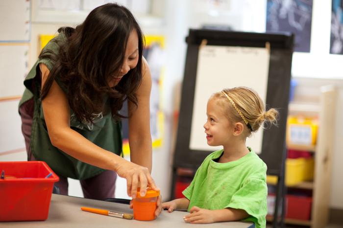 A photo of a teacher and a preschooler