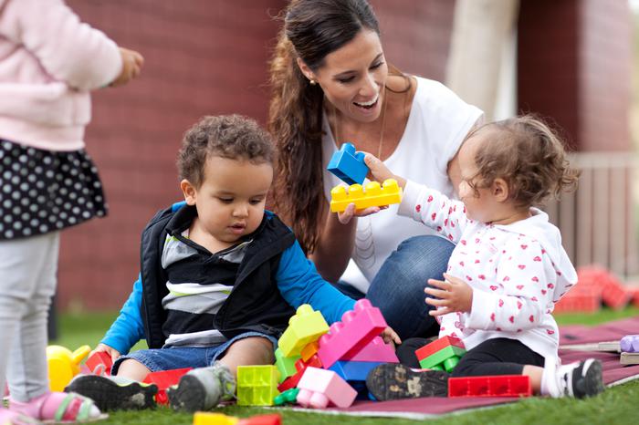 A picture of children at play with a teacher